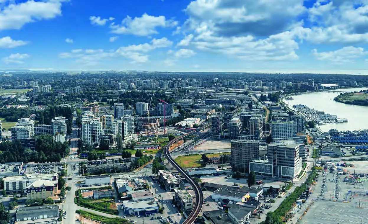Aerial view of Richmond city centre with the Fraser River and Metro Vancouver beyond.