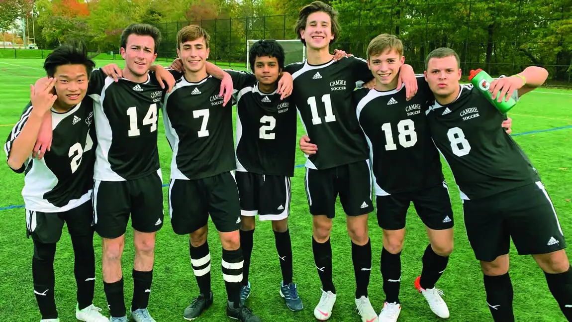 A Richmond secondary school soccer team standing together on the field.