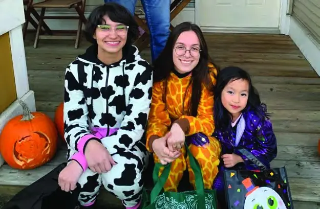 A homestay family and student in Halloween costumes at home in Richmond.