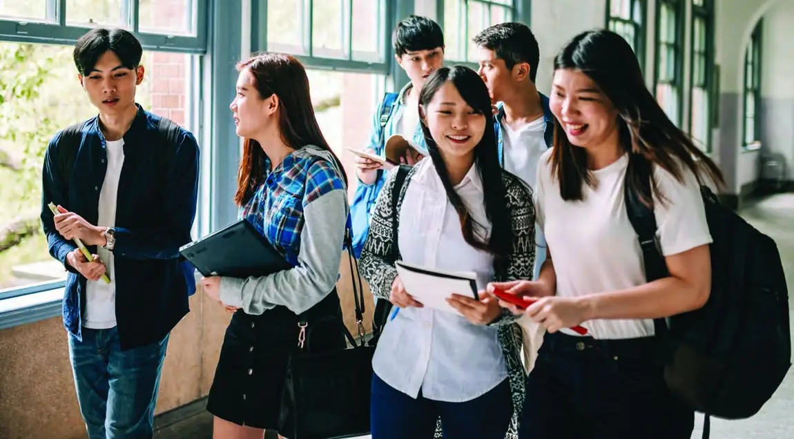 Students walking and talking together in a Richmond secondary school hallway.